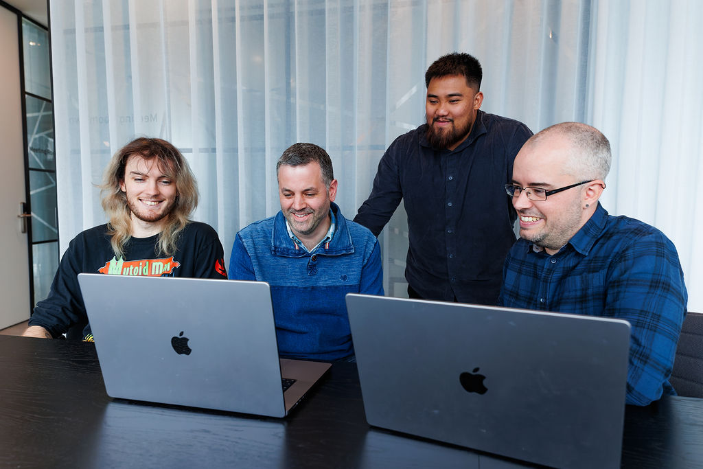 MakeCloud team collaborating around laptops