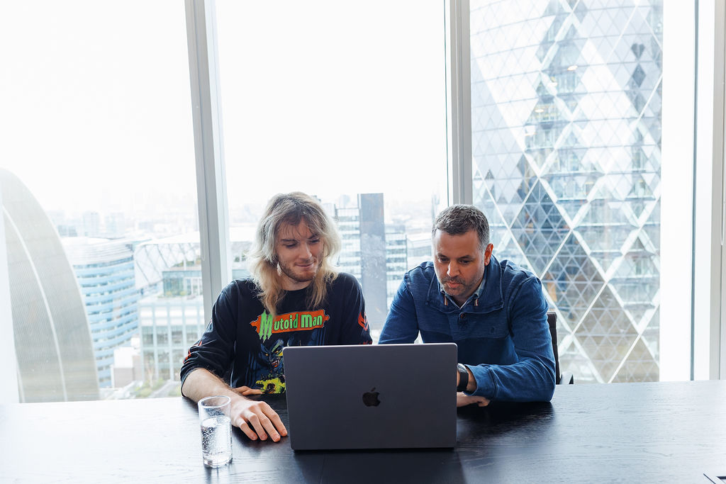 Pair working with London skyline